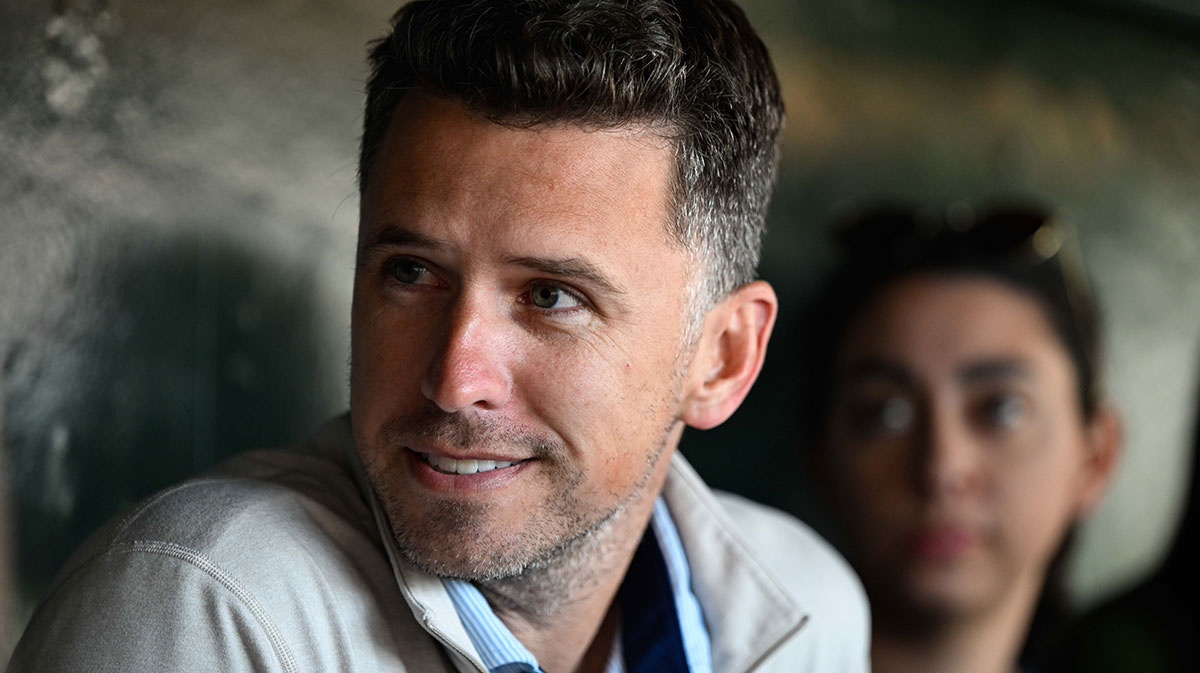Former San Francisco Giants player Buster Posey sits in the dugout before the game against the San Diego Padres at Oracle Park.