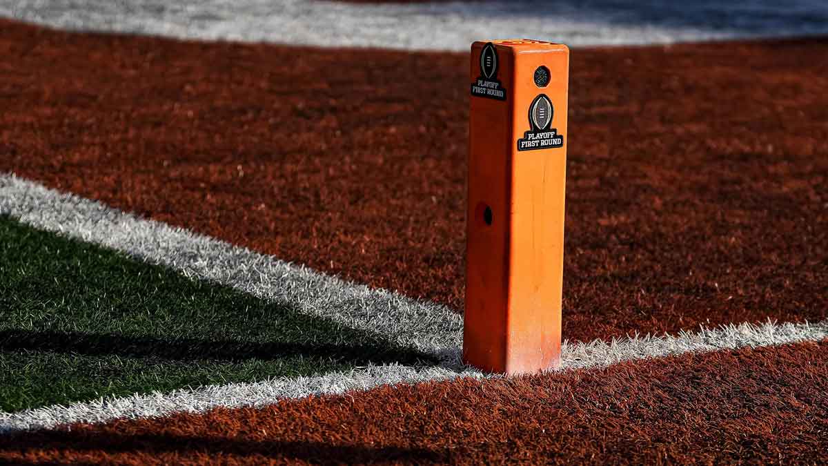 College Football Playoff logos are added to pylons during the game between the Texas Longhorns and Clemson in the first round of the College Football Playoffs at Darrell K Royal-Texas Memorial Stadium