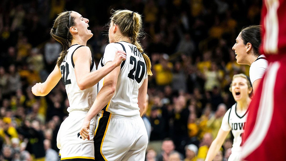 Iowa guard Caitlin Clark, left, celebrates with teammates Kate Martin (20) and McKenna Warnock during a NCAA Big Ten Conference women's basketball game against Indiana.
