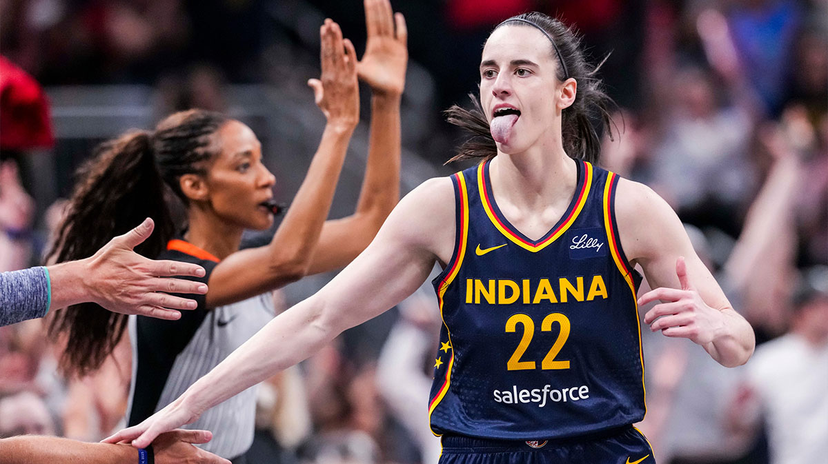 Indiana Fever guard Caitlin Clark (22) high-fives fans after scoring a 3-pointer Saturday, June 14, 2025, during a game between the Indiana Fever and the New York Liberty at Gainbridge Fieldhouse in Indianapolis.