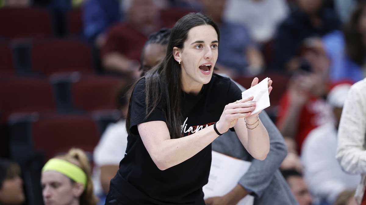 Indiana Fever guard Caitlin Clark (22) applauds her teammates during the first half of a WNBA game against the Chicago Sky at United Center.