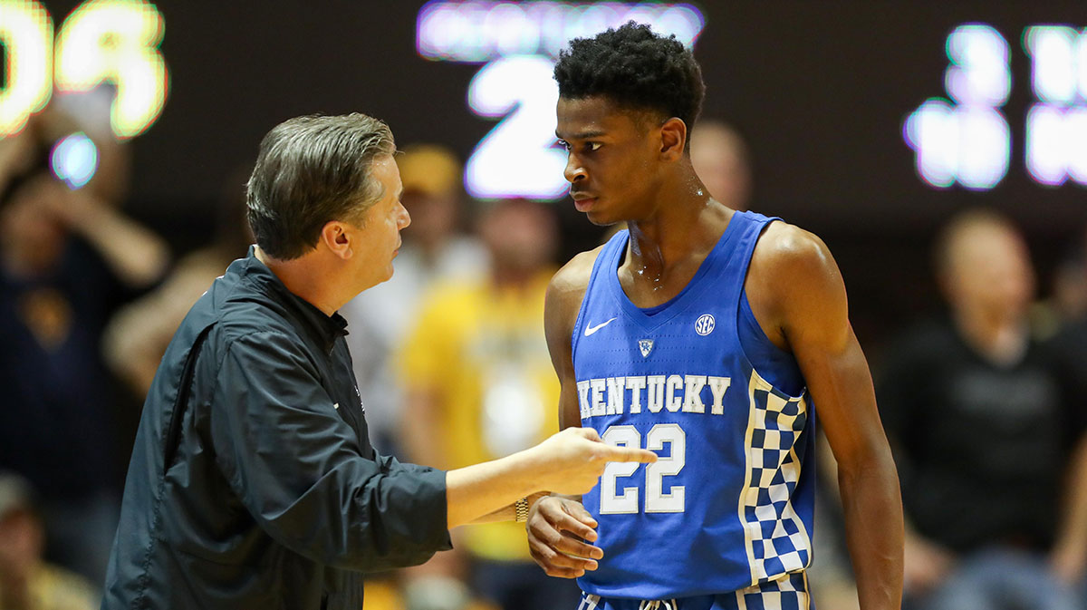Kentucky Wildcats head coach John Calipari talks with Kentucky Wildcats guard Shai Gilgeous-Alexander (22) during the first half against the West Virginia Mountaineers at WVU Coliseum.