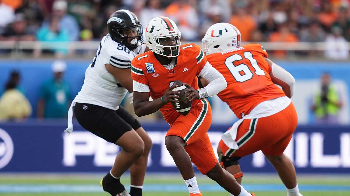 Miami Hurricanes quarterback Cam Ward (1) scrambles with the ball against the Iowa State Cyclones during the first half at Camping World Stadium.