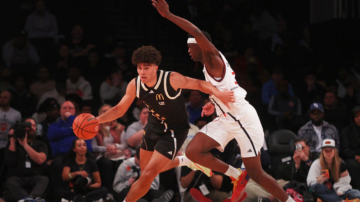 Apr 1, 2025; Brooklyn, NY, USA; McDonald's All American East forward Cameron Boozer (12) dribbles the ball against McDonald's All American West forward AJ Dybantsa (3) during the second half of the game at Barclays Center.