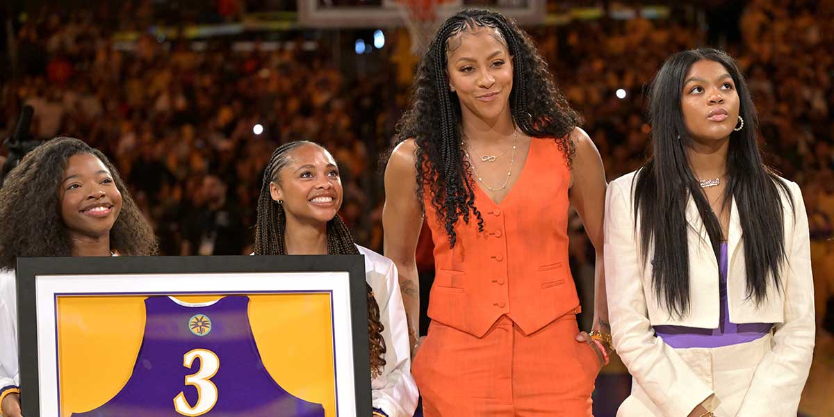 Former Los Angeles Sparks Candace Parker stands next to her daughter, white jacket, Lailaa Nicole Williams, as she acknowledges the crowd during a jersey retirement ceremony at halftime.