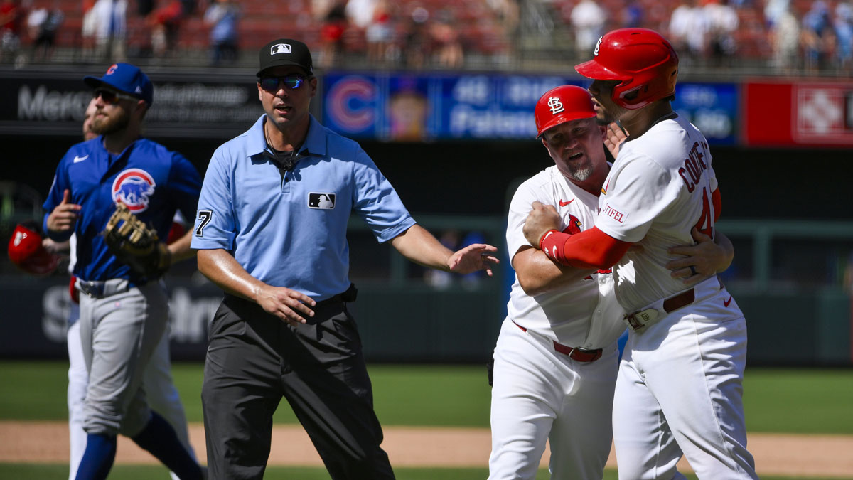 St. Louis Cardinals first baseman Willson Contreras (40) is held back by first base coach Stubby Clapp (82) as he exchanges words with Chicago Cubs relief pitcher Daniel Palencia (not pictured) after the Cubs defeated the Cardinals at Busch Stadium.