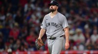 New York Yankees pitcher Carlos Rodon (55) reacts after striking out Los Angeles Angels left fielder Chris Taylor (33) to end the seventh inning at Angel Stadium.