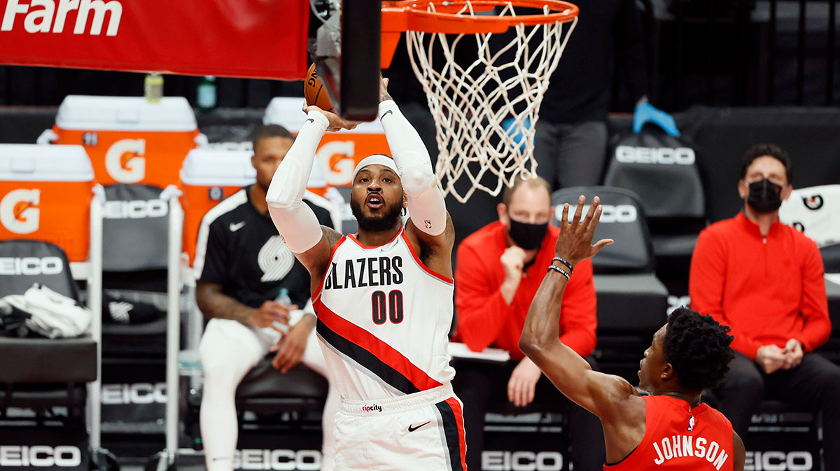 Portland Trail Blazers power forward Carmelo Anthony (00) shoots the ball over Toronto Raptors small forward Stanley Johnson (5) during the first half at Moda Center.