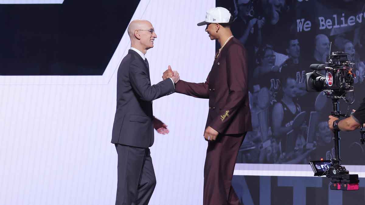 Carter Bryant stands with NBA commissioner Adam Silver after being selected as the 14th pick by the San Antonio Spurs in the first round of the 2025 NBA Draft at Barclays Center.