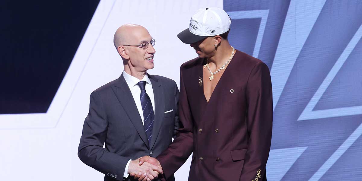 Carter Bryant stands with NBA commissioner Adam Silver after being selected as the 14th pick by the San Antonio Spurs in the first round of the 2025 NBA Draft at Barclays Center.