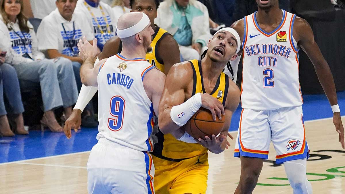 Indiana Pacers guard Andrew Nembhard (2) collides with Oklahoma City Thunder guard Alex Caruso (9) during the second quarter in game five of the 2025 NBA Finals at Paycom Center.