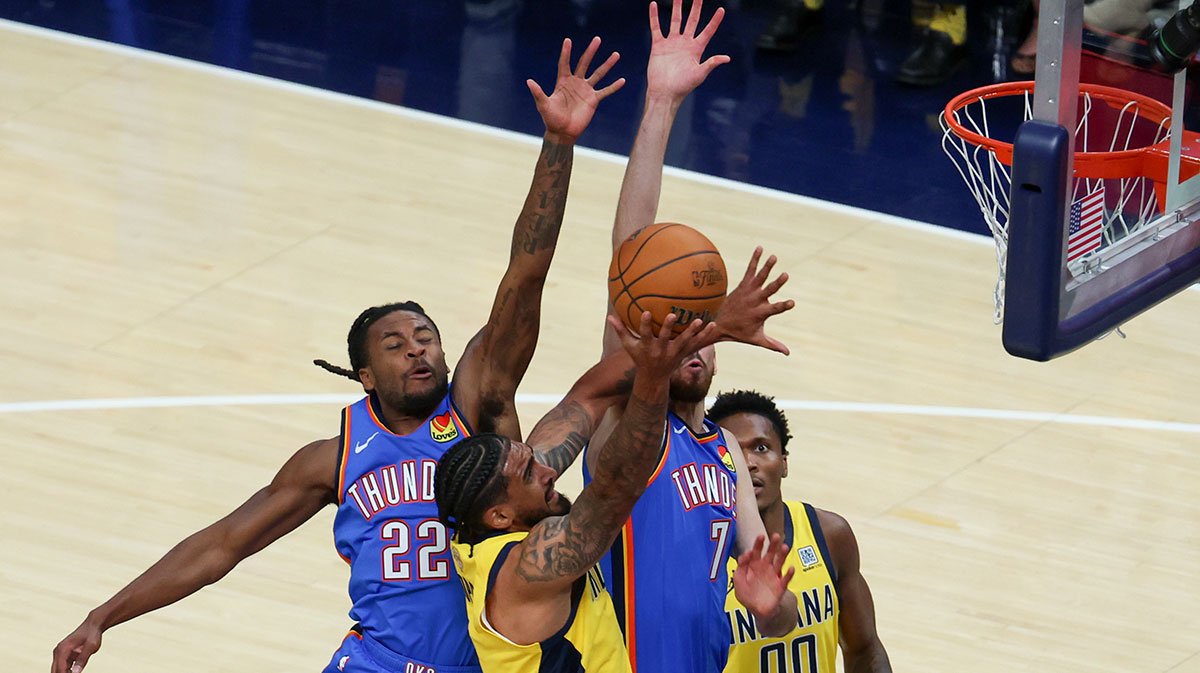 Indiana Pacers forward Obi Toppin (1) shoots the ball against Oklahoma City Thunder guard Cason Wallace (22) and forward Chet Holmgren (7) in the first quarter during game six of the 2025 NBA Finals at Gainbridge Fieldhouse.