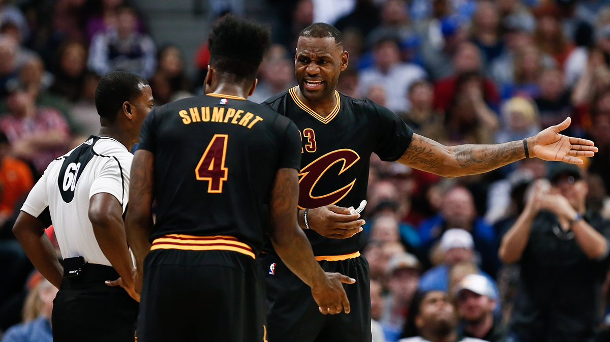 Cleveland Cavaliers forward LeBron James (23) and guard Iman Shumpert (4) talk with referee James Williams (60) in the fourth quarter against the Denver Nuggets at the Pepsi Center. The Cavaliers defeated the Nuggets 93-87.