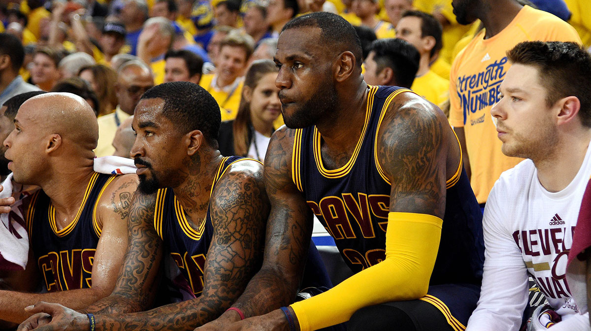 Cavaliers forward LeBron James (23) and Cleveland Cavaliers guard J.R. Smith (5) sit on the bench during the fourth quarter against the Golden State Warriors in game one of the NBA Finals at Oracle Arena