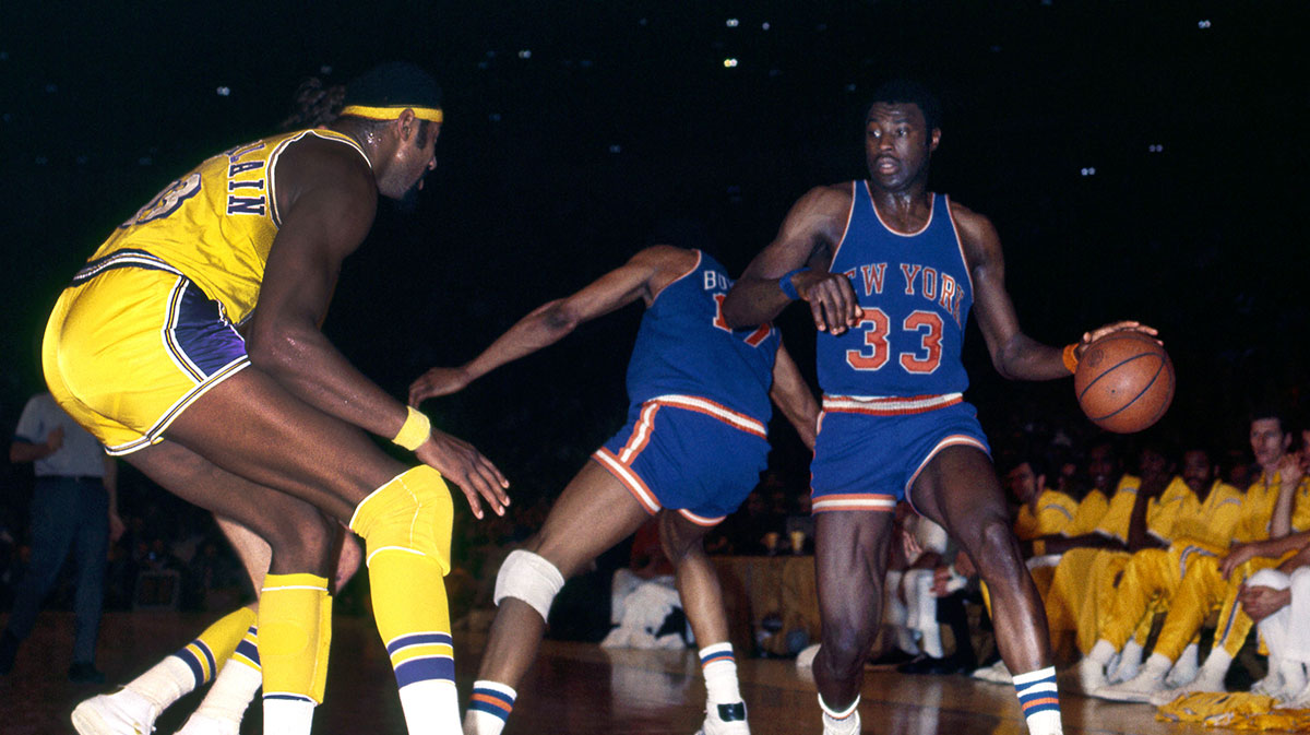 Los Angeles Lakers center Wilt Chamberlain (13) guards New York Knicks forward Cazzie Russell (33) at the Forum.
