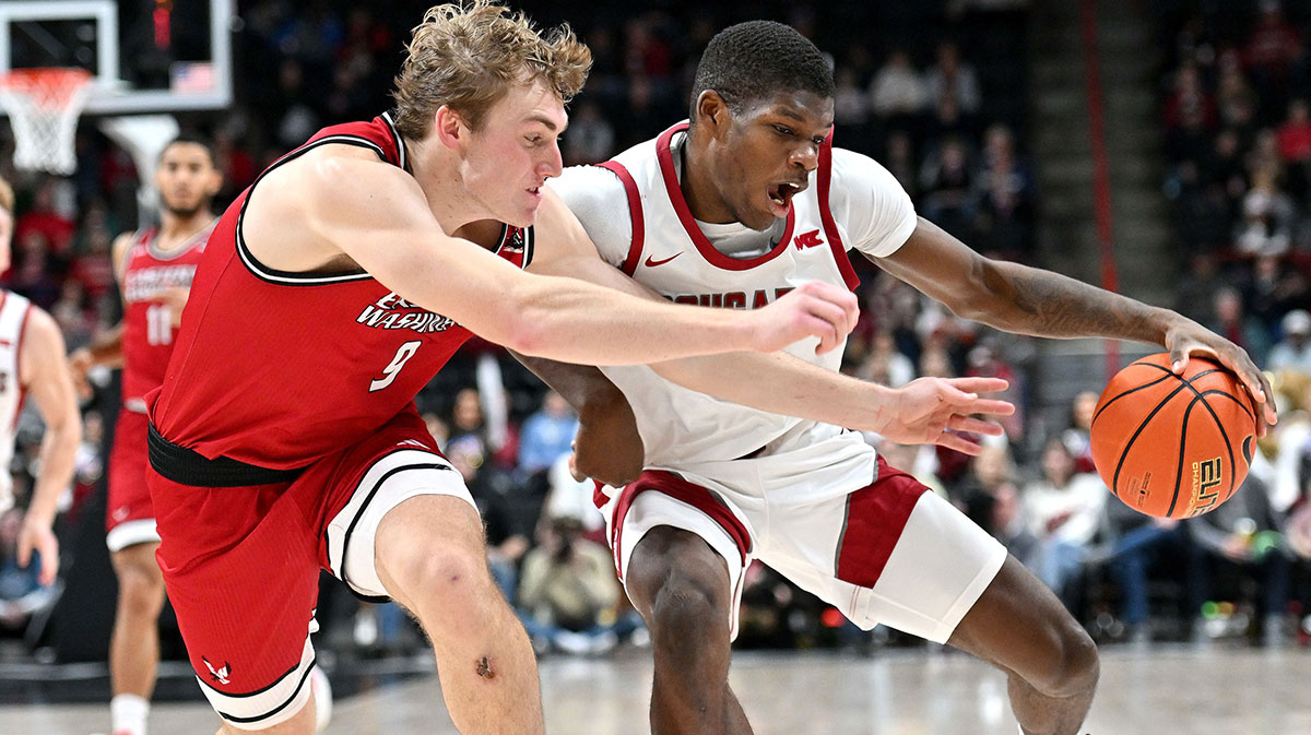 Washington State Cougars guard Cedric Coward (0) controls the ball against Eastern Washington Eagles guard Andrew Cook (9) in the first half at Spokane Veterans Memorial Arena.