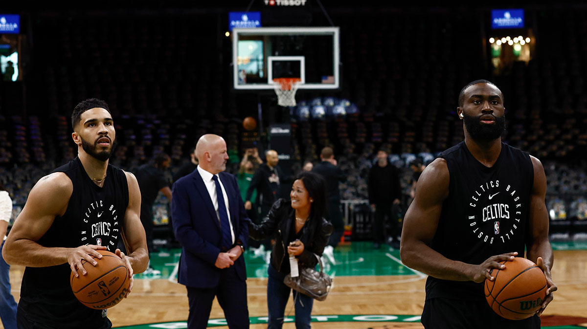 Celtics forward Jayson Tatum (0) and guard Jaylen Brown (7) warm up before their game against the Phoenix Suns at TD Garden