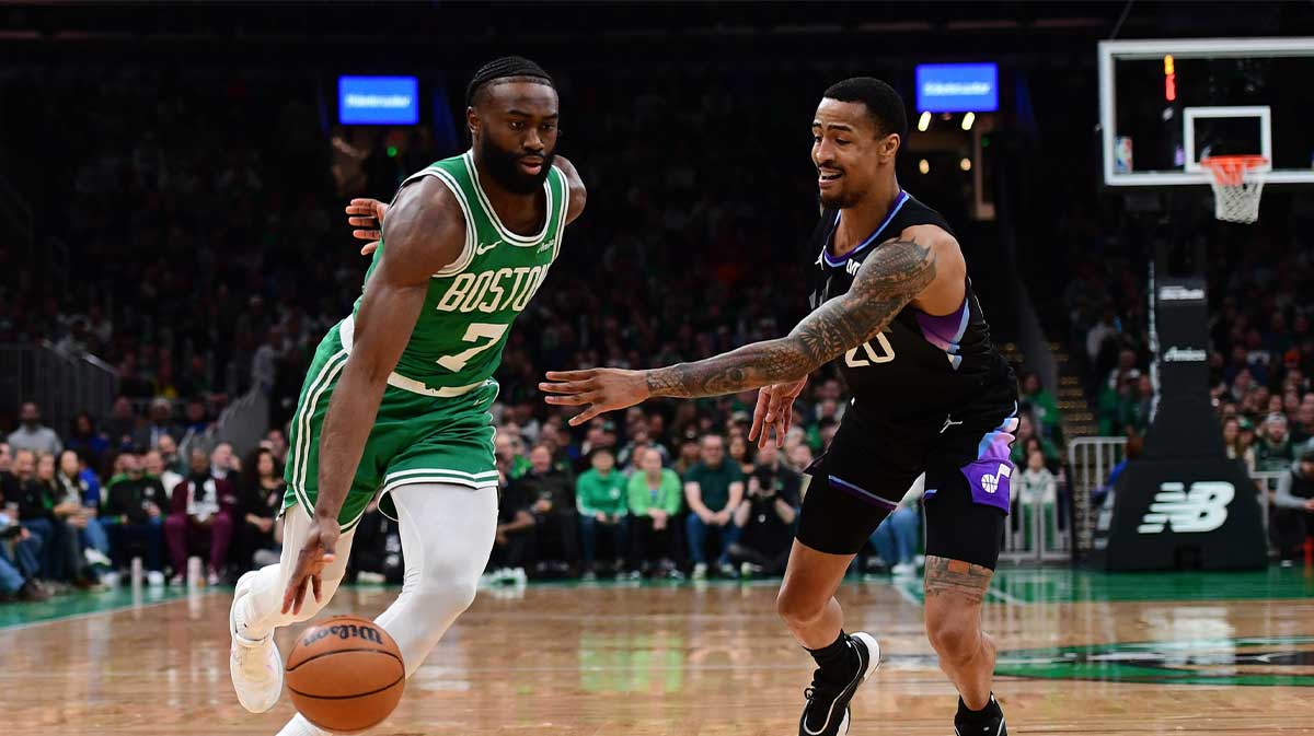 Celtics guard Jaylen Brown dribbles around Jazz's John Collins