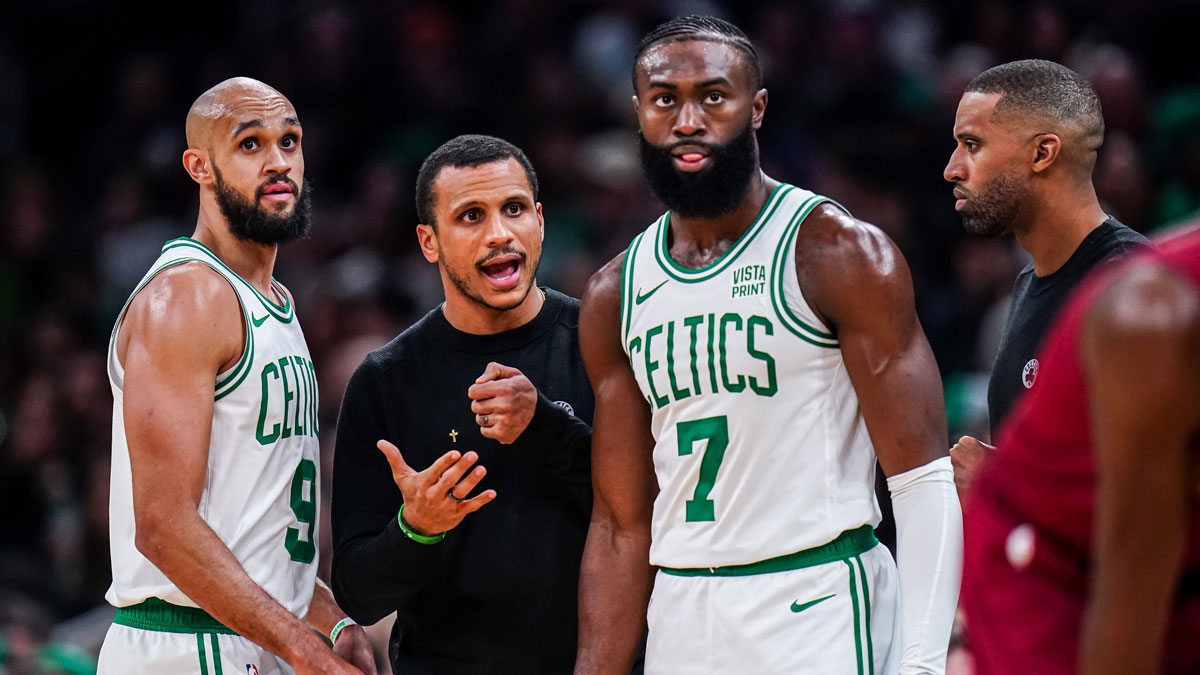 Boston Celtics head coach Joe Mazzulla talks with guard Jaylen Brown (7) and guard Derrick White (9) from the sideline as they take on the Cleveland Cavaliers at TD Garden.