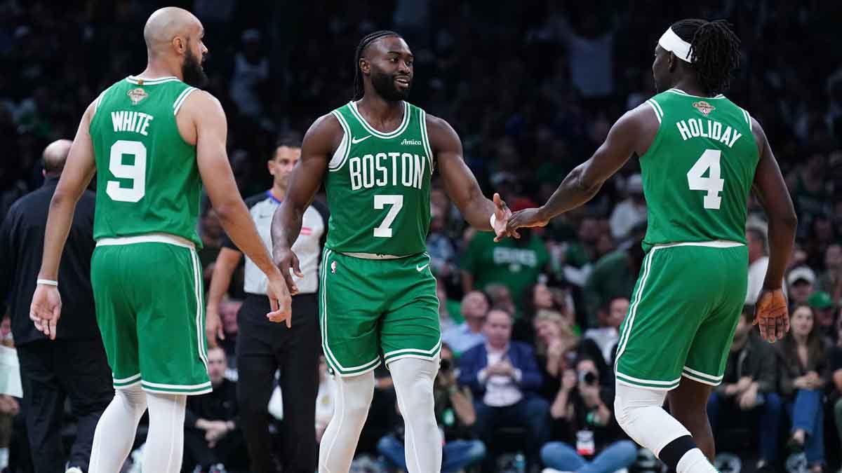 Boston Celtics guard Jaylen Brown (7), guard Jrue Holiday (4) and guard Derrick White (9) react after a play against the New York Knicks in the second half at TD Garden.