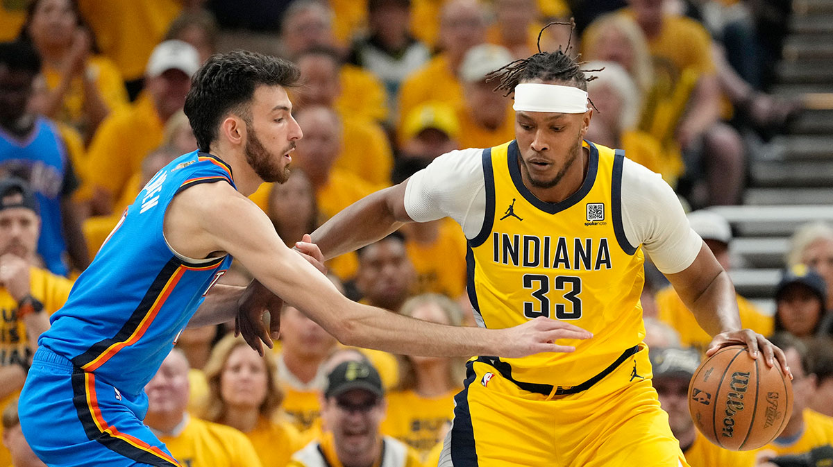 Indiana Pacers center Myles Turner (33) dribbles the ball against Oklahoma City Thunder forward Chet Holmgren (7) during the first half during game three of the 2025 NBA Finals at Gainbridge Fieldhouse.