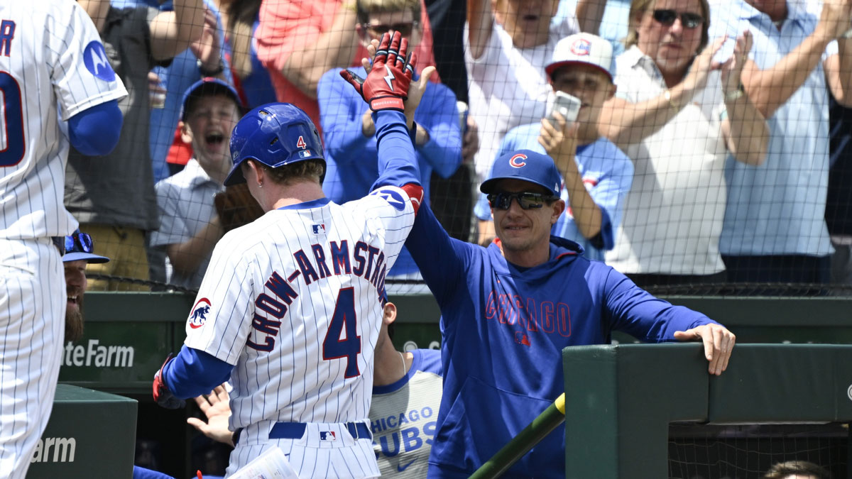 Chicago Cubs outfielder Pete Crow-Armstrong (4) high fives manager Craig Counsell after he hits a two run home run against the Milwaukee Brewers during the first inning at Wrigley Field.