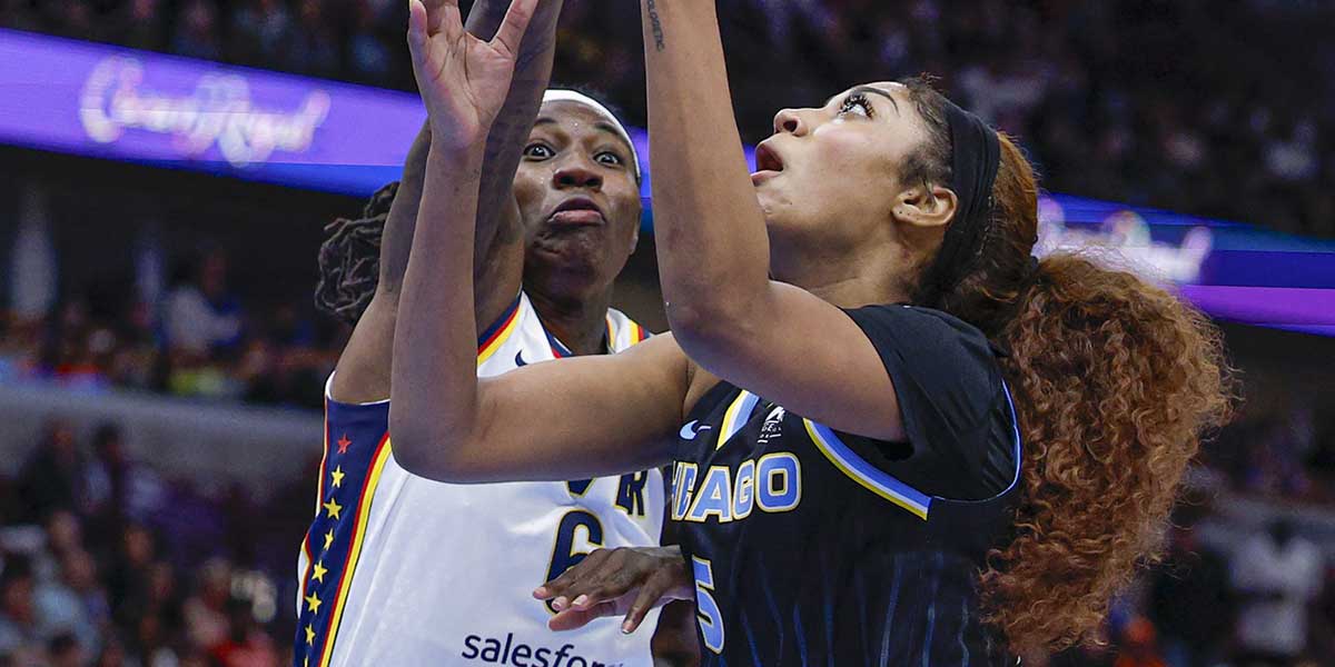Chicago Sky forward Angel Reese (5) drives to the basket against Indiana Fever forward Natasha Howard (6) during the second half of a WNBA game at United Center.