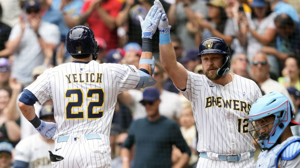 Milwaukee Brewers designated hitter Christian Yelich (22) is greeted by first baseman Rhys Hoskins (12) after hitting a home run during the fourth inning against the St. Louis Cardinals at American Family Field.
