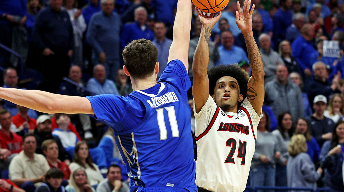 Louisville Cardinals guard Chucky Hepburn (24) shoots the ball again Creighton Bluejays center Ryan Kalkbrenner (11) in the first round of the NCAA Tournament at Rupp Arena.