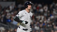 New York Yankees outfielder Cody Bellinger (35) hits a single against the Boston Red Sox during the sixth inning at Yankee Stadium.