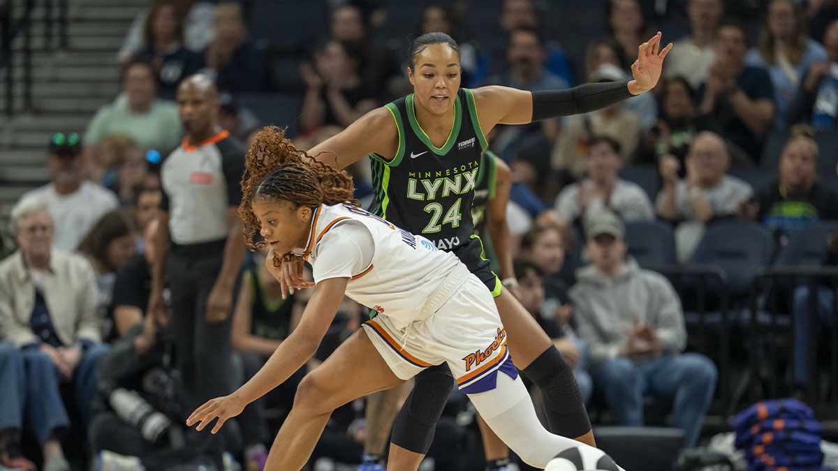 Phoenix Mercury guard Monique Akoa Makani (8) dribbles the ball off her foot as Minnesota Lynx forward Napheesa Collier (24) plays defense in the first half at Target Center.