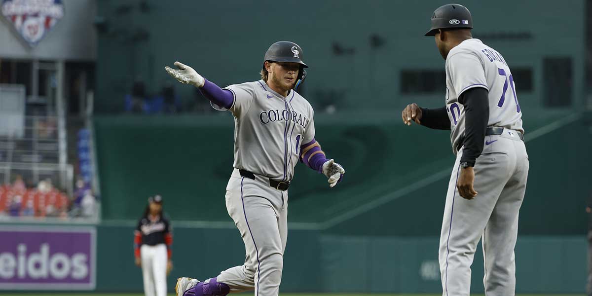 Colorado Rockies catcher Hunter Goodman (15) celebrates with Rockies third base coach Andy González (70) while rounding the bases after hitting a two run home run against the Washington Nationals during the first inning at Nationals Park.