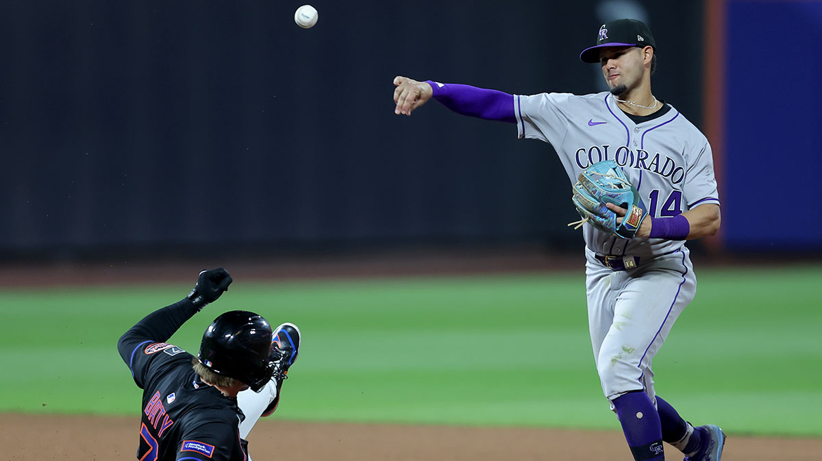 Colorado Rockies shortstop Ezequiel Tovar (14) forces out New York Mets third baseman Brett Baty (7) at second base and throws to first to complete a double play on a ball hit by Mets right fielder Juan Soto (not pictured) during the eighth inning at Citi Field.