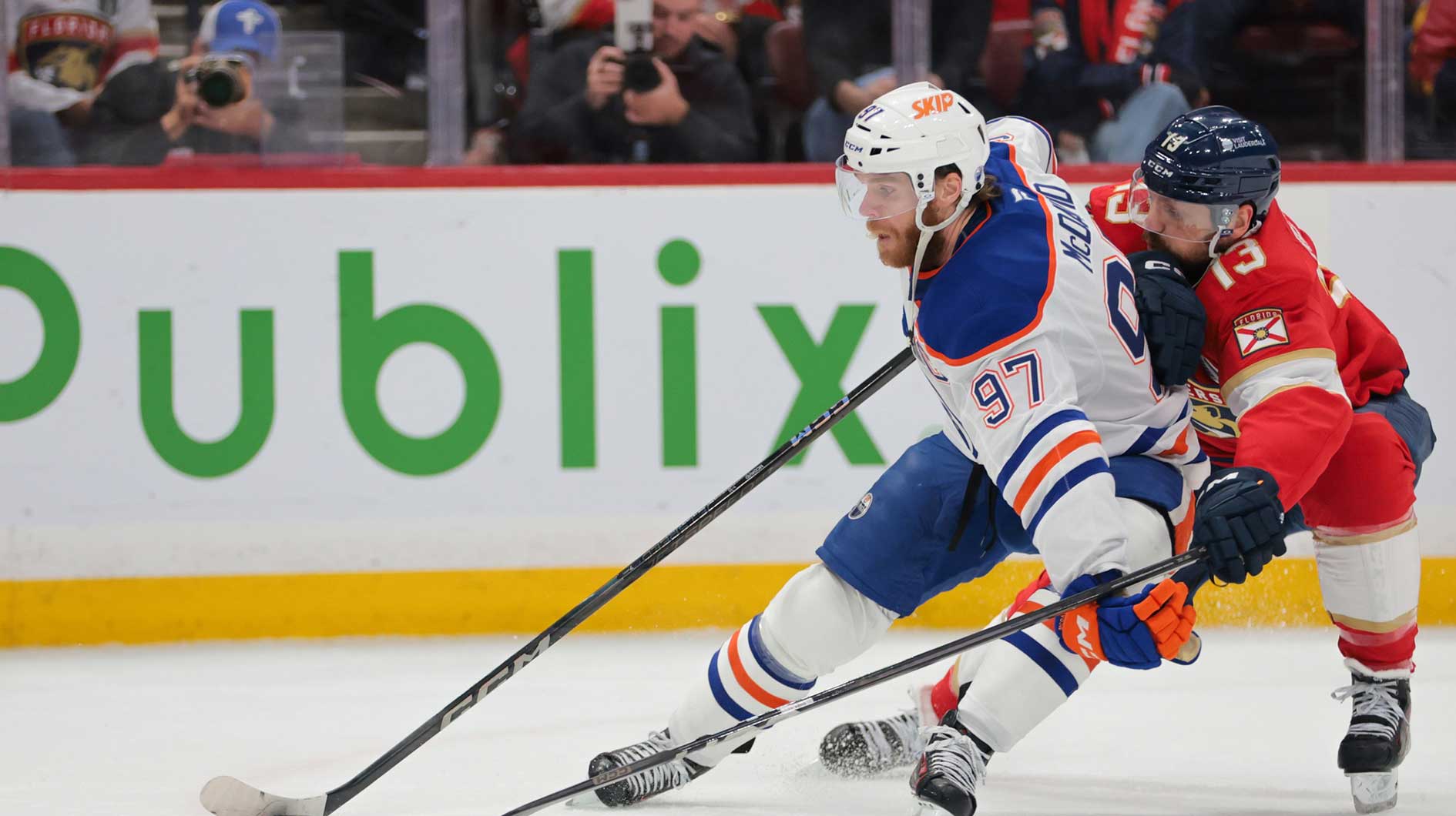 Edmonton Oilers center Connor McDavid (97) controls the puck defended by Florida Panthers center Sam Reinhart (13) during the first period in game six of the 2025 Stanley Cup Final at Amerant Bank Arena.