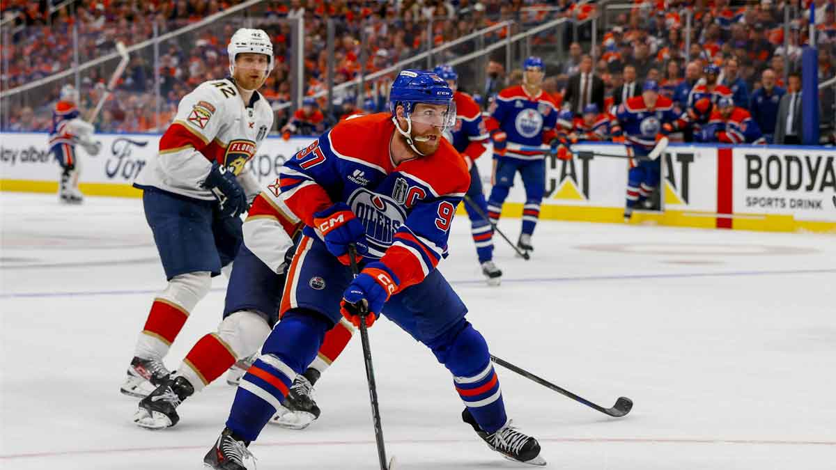 Edmonton Oilers center Connor McDavid (97) controls the puck against Florida Panthers forward Aleksander Barkov (16) during the third period in game five of the 2025 Stanley Cup Final at Rogers Place.