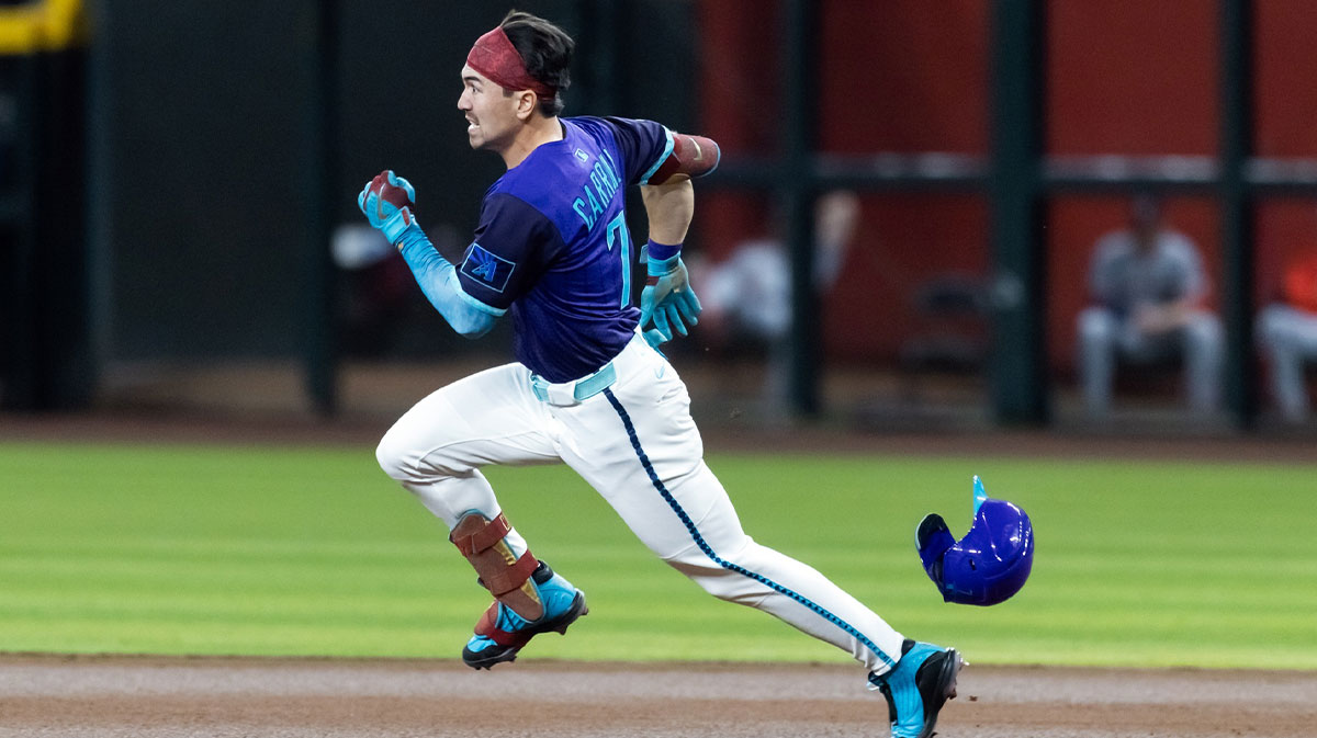 Arizona Diamondbacks outfielder Corbin Carroll loses his helmet as he runs to second with a first inning double against the Washington Nationals at Chase Field