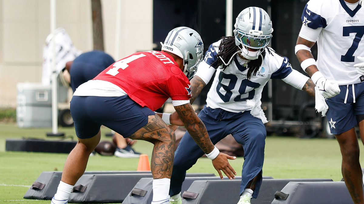 Dallas Cowboys quarterback Dak Prescott (4) celebrates with Dallas Cowboys wide receiver CeeDee Lamb (88) during a drill at the Ford Center at the Star Training Facility in Frisco, Texas.