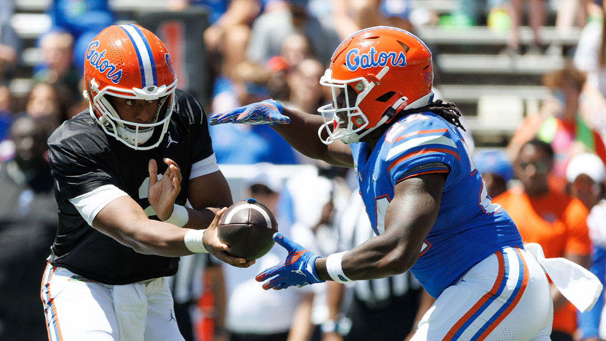 Florida Gators quarterback DJ Lagway (2) hands the ball to Florida Gators running back Ja'Kobi Jackson (24) during the first half at Ben Hill Griffin Stadium.