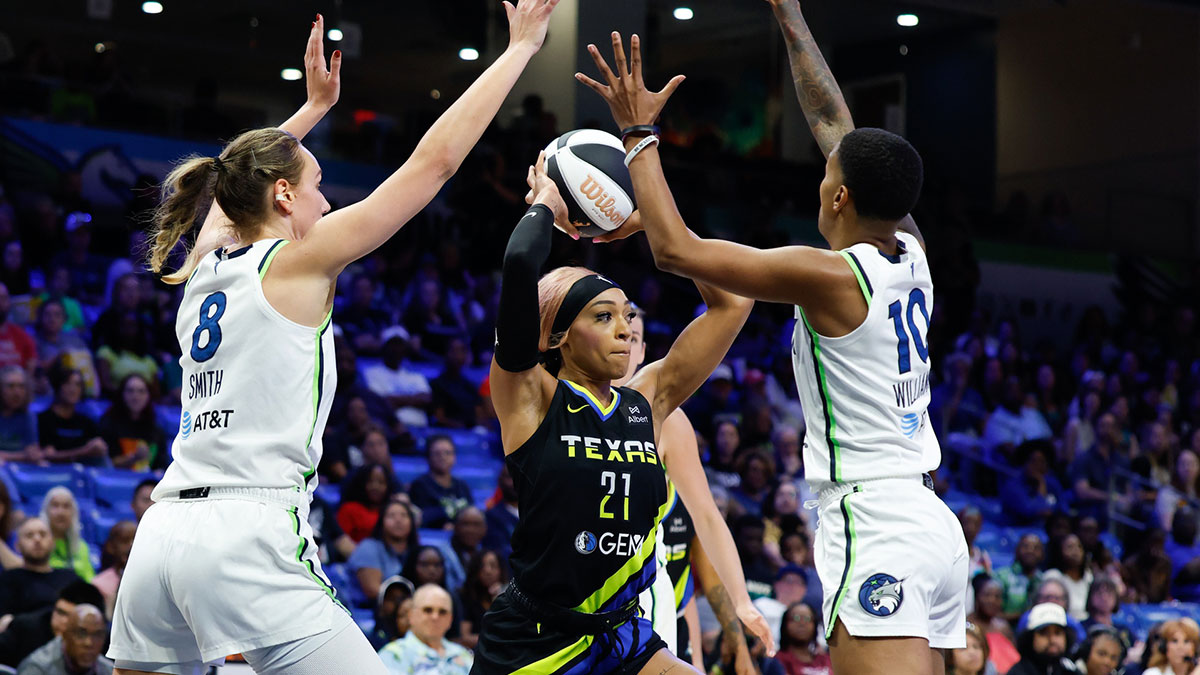 Dallas Wings guard DiJonai Carrington (21) looks to pass between Minnesota Lynx forward Alanna Smith (8) and guard Courtney Williams (10) during the first half at College Park Center.