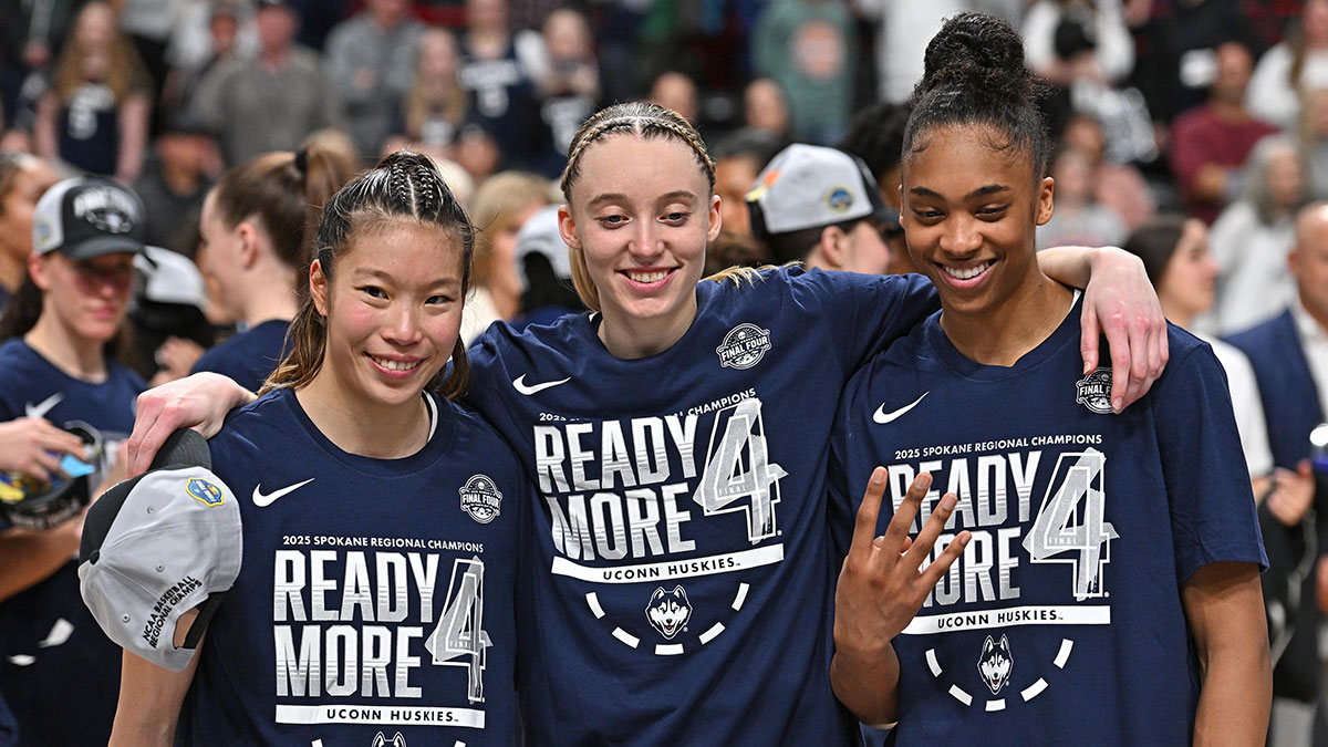 UConn Huskies guard Kaitlyn Chen (20), guard Paige Bueckers (5) and forward Aubrey Griffin (44) pose for a photo after a Elite 8 NCAA Tournament basketball game against the USC Trojans at Spokane Arena. Wings