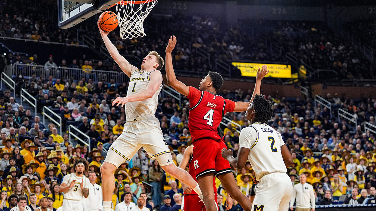 Michigan Wolverines center Danny Wolf (1) lays it up against Rutgers Scarlet Knights guard Ace Bailey (4) during the second half at Crisler Center