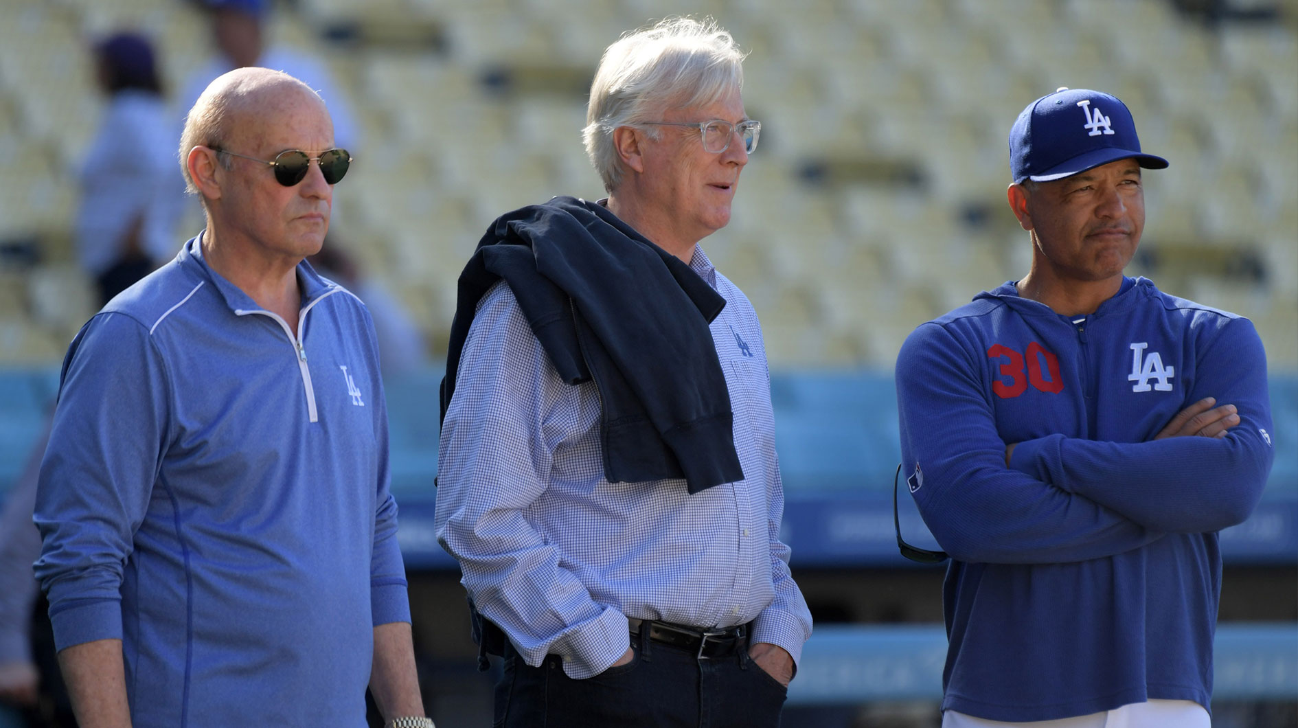 Los Angeles Dodgers president Stan Kasten (left), chairman and controlling owner Mark Walter (center) and manager Dave Roberts watch batting practice prior to the game against the New York Mets at Dodger Stadium.