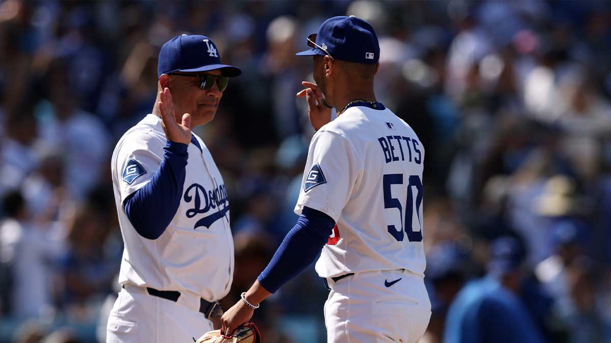 Los Angeles Dodgers manager Dave Roberts (30) and shortstop Mookie Betts (50) celebrate after defeating the New York Mets at Dodger Stadium.