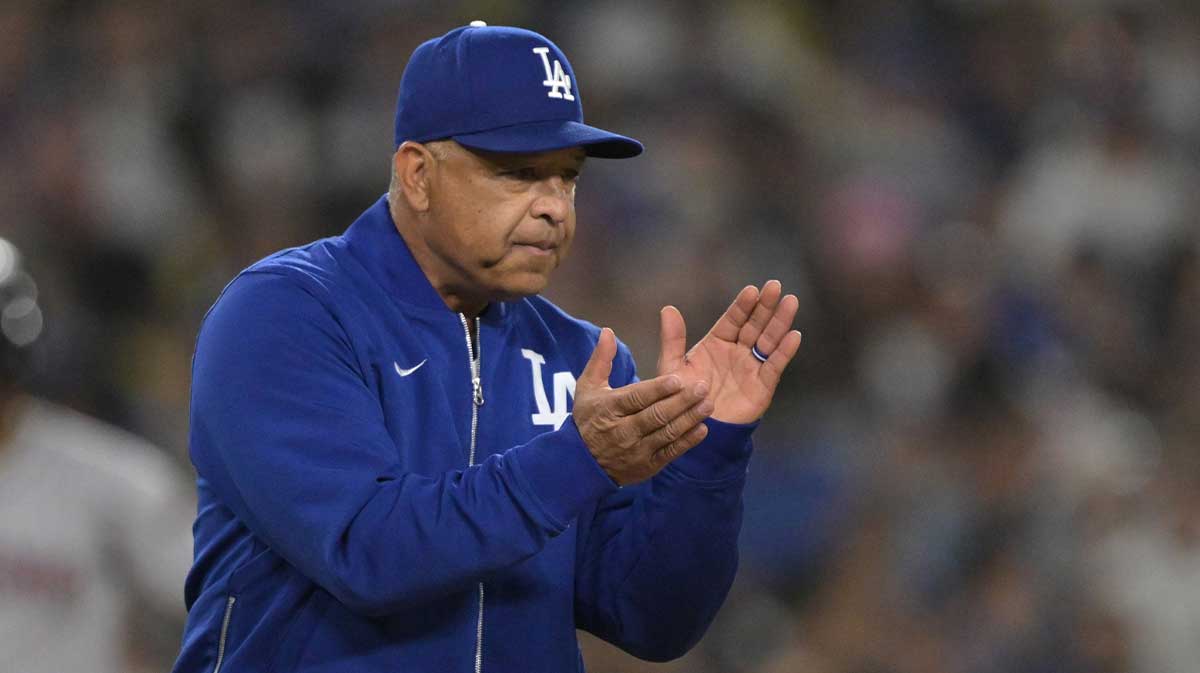 May 21, 2025; Los Angeles, California, USA; Los Angeles Dodgers manager Dave Roberts (30) walks to the mound for a pitching change in the eighth inning against the Arizona Diamondbacks at Dodger Stadium. Mandatory Credit: Jayne Kamin-Oncea-Imagn Images