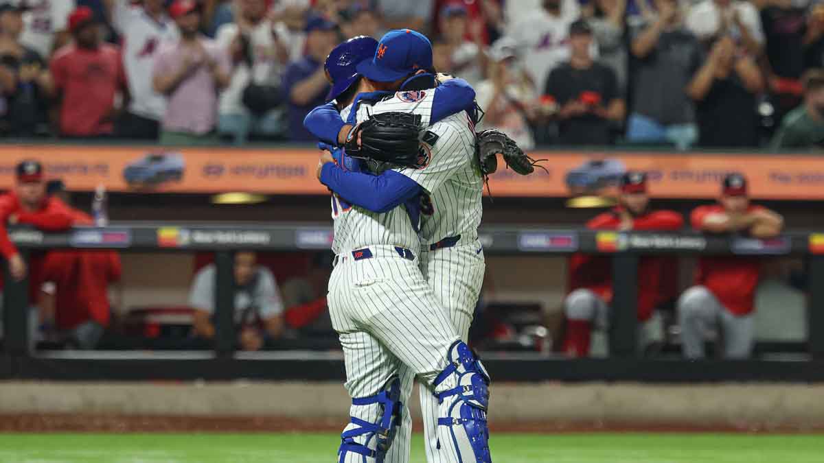 New York Mets starting pitcher David Peterson (23) celebrates with catcher Luis Torrens (13) after defeating the Washington Nationals.