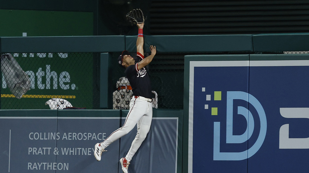 Jun 16, 2025; Washington, District of Columbia, USA; Washington Nationals outfielder Daylen Lile (51) attempts to catch a home run at the fence hit by Colorado Rockies outfielder Mickey Moniak (not pictured) during the ninth inning at Nationals Park. Mandatory Credit: Geoff Burke-Imagn Images