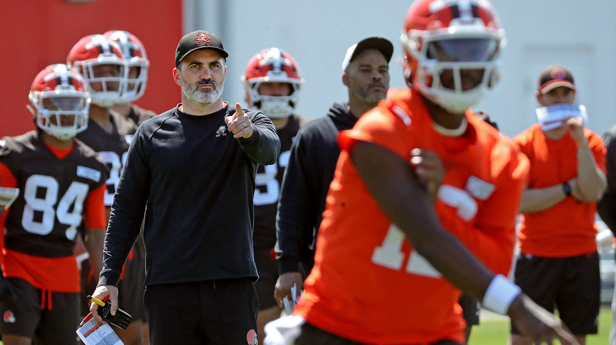 Cleveland Browns coach Kevin Stefanski watches quarterback Shedeur Sanders (12) participate in drills during day two of NFL rookie minicamp at the Cleveland Browns training facility May 10, 2025, in Berea, Ohio.