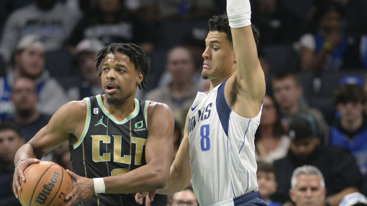 Charlotte Hornets guard Dennis Smith Jr. (8) looks to pass as he is defended by Dallas Mavericks guard Josh Green (8) during the first half at the Spectrum Center.