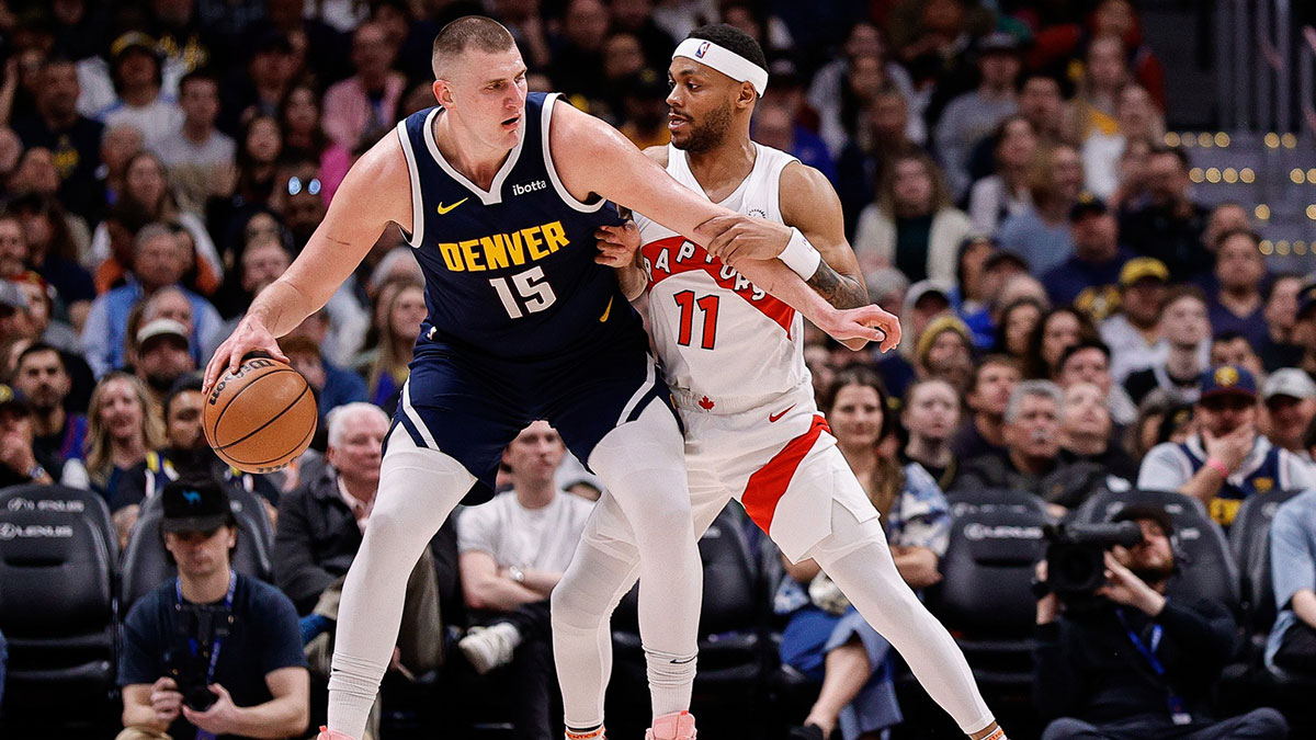 Denver Nuggets center Nikola Jokic (15) controls the ball as Toronto Raptors forward Bruce Brown (11) guards in the second quarter at Ball Arena.