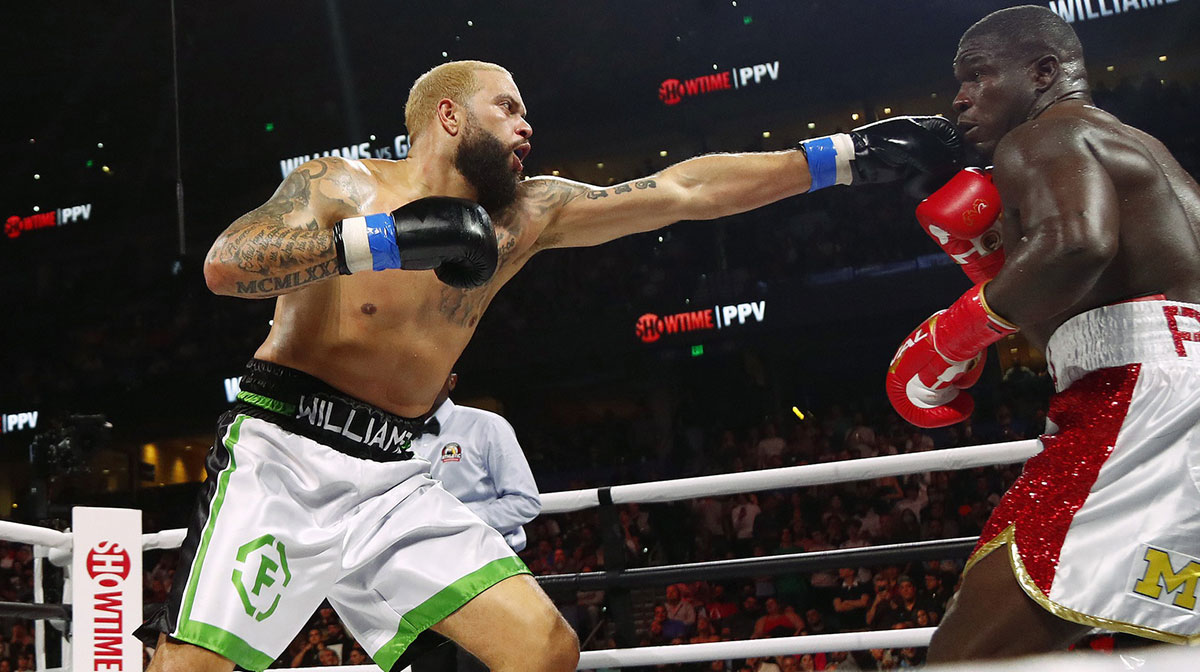 Deron Williams (blue gloves) fights Frank Gore (red gloves) at Amalie Arena.